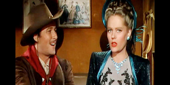 Errol Flynn as Clay Hardin and Alexis Smith as Jeanne Starr, learning she'll be performing in a saloon in San Antonio (1945)