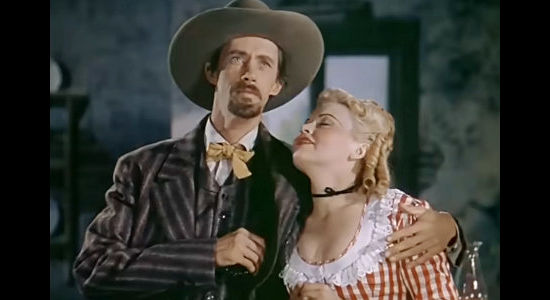 John Carradine as Bob Ford and Barbara Pepper as Nellie Blane, acting out a phony version of Jesse's death in The Return of Frank James (1940)