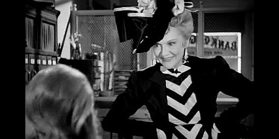 Minna Gombell as Emily, the saloon matron who does business with Bill Doolin, making a fat bank deposit in Return of the Bad Men (1948)