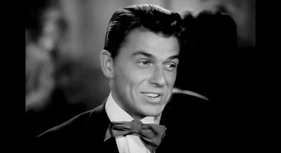 Ronald Reagan as George Armstrong Custer, fresh out of West Point and fascinated by 'Kit Carson' Holliday in Santa Fe Trail (1940)