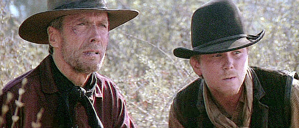 Clint Eastwood as Bill Munny and Jaimz Woolvett as The Schofield Kid waiting for their prey to show in Unforgiven (1992)
