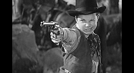 Darryl Hickman, practicing his six-gun skills with Baggot's help in Jackass Mail (1942)