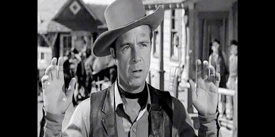 Dick Powell as Haven, trying to avoid as assassin's bullet by surrounding to a sheriff in Station West (1948)