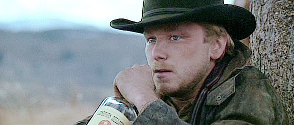 Jaimz Woolvett as The Schofield Kid, trying to drown the shock of his first killing with alcohol in Unforgiven (1992)