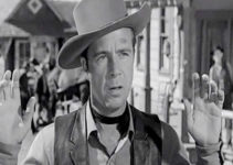 Dick Powell as Haven, trying to avoid as assassin's bullet by surrounding to a sheriff in Station West (1948)