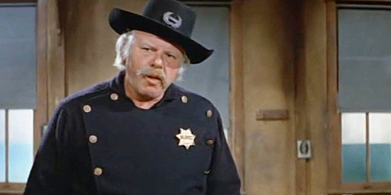 Alan Hale Jr. as Tobaccy, a prison guard sensing something amiss in There Was a Crooked Man (1970)