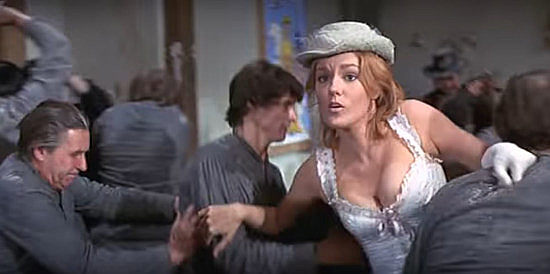 Barbara Rhoades as Miss Jessie Brundidge, a school teacheer caught among the rioting prisoners in There Was a Crooked Man (1970)