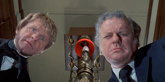 Bill McKinney as the Rev. Peabody and Charles Durning as Frank O'Brien, studying a dead body in Breakheart Pass (1974)