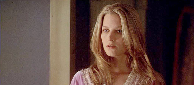 Bridget Fonda as Adalyne Dunfries, realizing the Henrys men to cause her trouble in South of Heaven, West of Hell (2000)