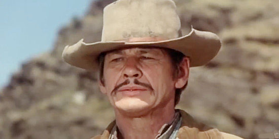 Charles Bronson as Chino Valdez, falling for a woman he shouldn't fall for in Chino (1973)