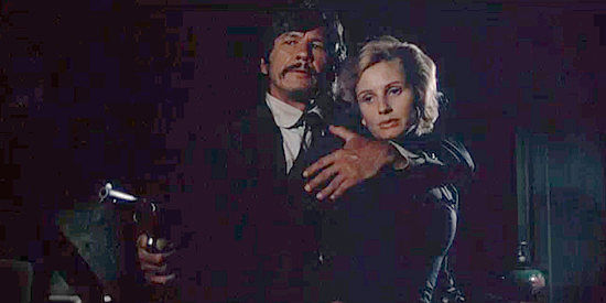 Charles Bronson as Graham Dorsey reacts to a jar of preserves breaking by clutching Amanda Starbuck (Jill Ireland) in From Noon Till Three (1974)