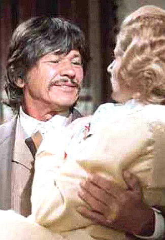 Charles Bronson as Graham Dorsey sweeps Jill Ireland as Amanda Starbuck off her feet in From Noon Till Three (1975)