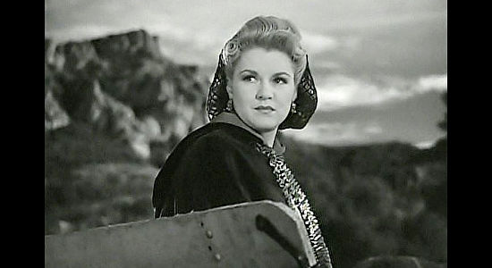 Claire Trevor as Mary McCloud, watching Bob Seton ride off to Texas in Dark Command (1940)