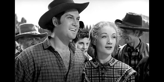 Clayton Moore as Paul Terry and Rowena Cook as his wife Alice, thrilled to learn they can follow Fremont's column West in Kit Carson (1940)