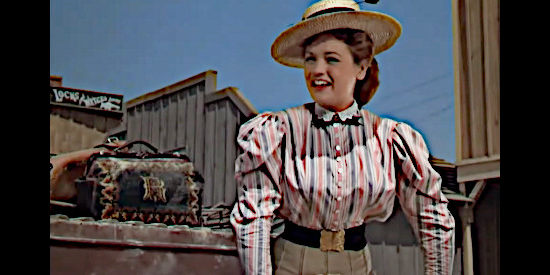 Dorothy Ford as Ruby Latham, the banker's daughter, arriving home and welcoming the first cowboys she sees in Three Godfathers (1948)