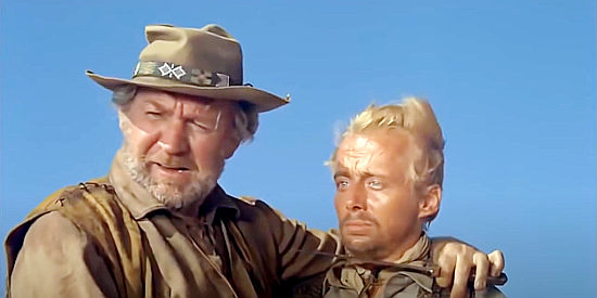 Forrest Tucker as Mountain Phil with Fair (John Davis Chandler), one of Remy's men, at knifepoint in Barquero (1970)