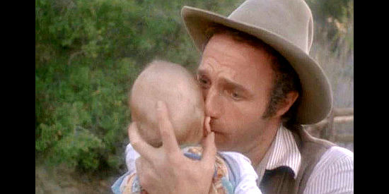 James Caan as David Williams, craddling his infant son after making a grisly discovery in Another Man, Another Chance (1977)