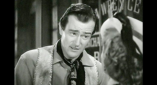 John Wayne as Bob Seton, introducing himself to a stunned Mary McCloud in Dark Command (1940)