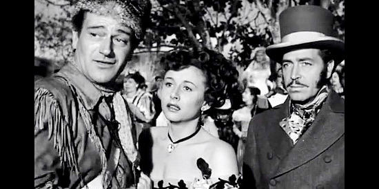 John Wayne as John Breen, Vera Ralston as Fleurette and John Howard as Blake Randolph watch a brawl break out in The Fighting Kentuckian (1949)