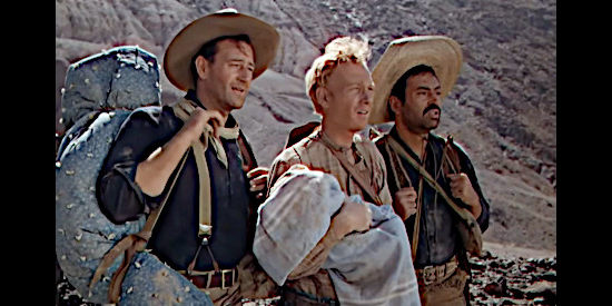 John Wayne as Robert Hightower, Harry Carey Jr. as William Kearney and Pedro Armendariz as Redro Roco Fuente, trying to save an infant in Three Godfathers (1948)