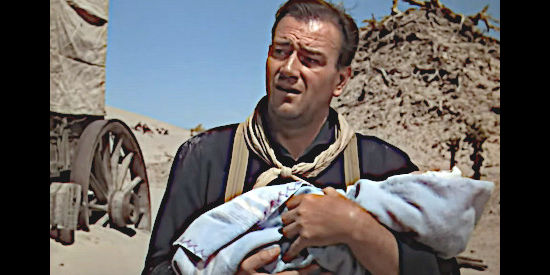 John Wayne as Robert Hightower with the infant he's going to have to help care for in Three Godfathers (1948)