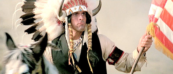 Jorge Rivero as Spotted Wolf, carrying a U.S. Flag and a flag of truce as his village is attacked in Soldier Blue (1970)