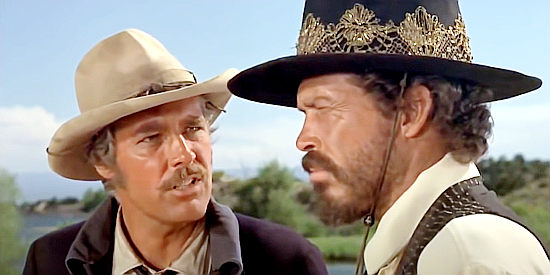 Kerwin Matthews as Marquette, trying to make a point with a stubborn Jack Remy (Warren Oates) in Barquero (1970)