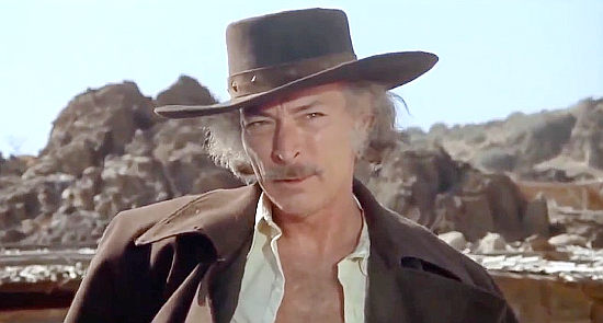 Lee Van Cleef as Kiefer, a bounty hunter without scruples in Take a Hard Ride (1975)