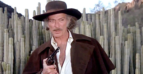 Lee Van Cleef as Kiefer, who finds more than a bounty to chase in Take a Hard Ride (1975)