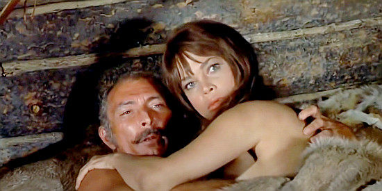 Lee Van Cleef as Travis and Maria Gomez as Nola, their cuddle time rudely interrupted in Barquero (1970)