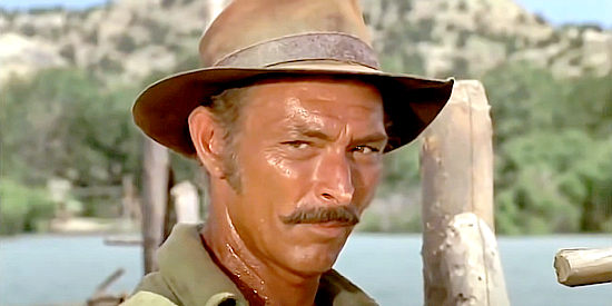 Lee Van Cleef as Travis, ready to defend the barge he built with his own hands in Barquero (1970)