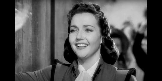 Lynn Bari as Dolores Murphy, bidding farewell to a new friend in Kit Carson (1940)