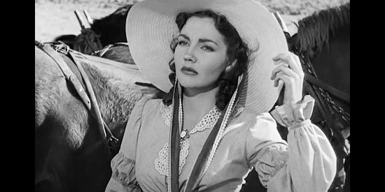 Lynn Bari as Dolores Murphy, the woman who offers Kit Carson $1,000 go guide the wagon train in Kit Carson (1940)