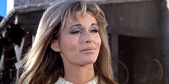 Marianna Hill as Claudine, warning Chavez that Luke is likely to bring trouble in El Condor (1970)