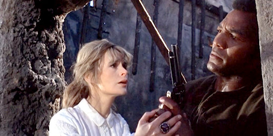 Marianne Hill as Claudine with Jim Brown as Luke, preparing for a final showdown in El Condor (1970)
