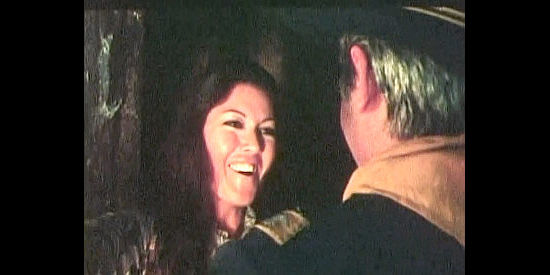 Marta Flores as Catherine welcoming her father, Capt. York, to her home though it will mean a new assignment for her husband in Federal Man (1974)