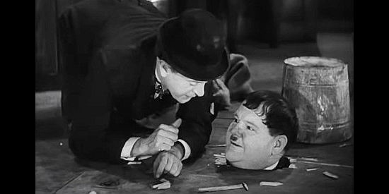 Oliver Hardy, stuck again as Stan Laurel tries to lend an assist in Way Out West (1937)