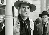 John Wayne as Bob Seton, sensing growing trouble in Lawence, Kansas as Fletch McCloud (Roy Rogers) looks on in Dark Command (1940)