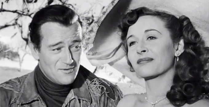 John Wayne as John Breen, smitten with Fleurete de Marchand (Vera Ralston) in The Fighting Kentuckian (1949)