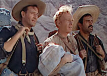 John Wayne as Robert Hightower, Harry Carey Jr. as William Kearney and Pedro Armendariz as Pedro Roco Fuente, trying to save an infant in Three Godfathers (1948)