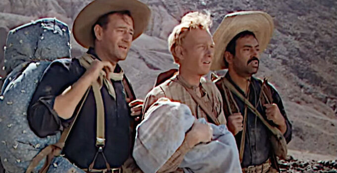 John Wayne as Robert Hightower, Harry Carey Jr. as William Kearney and Pedro Armendariz as Pedro Roco Fuente, trying to save an infant in Three Godfathers (1948)