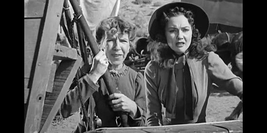 Renie Riano as Miss Pilchard and Lynn Bari as Dolores Murphy, spotting Kit Carson in trouble in Kit Carson (1940)