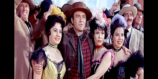 Robert Loggia as Johnny Quatro and his lady friends watch the president arrive in Cheyenne in Cattle King (1963)