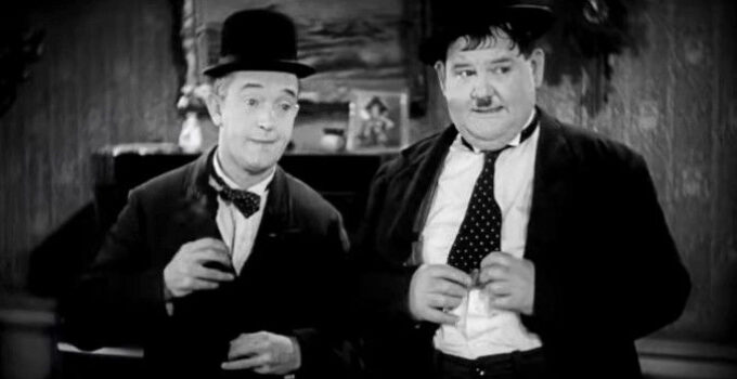 Stan Laurel and Oliver Hardy, trying their best to follow the sheriff's orders in Way Out West (1937)