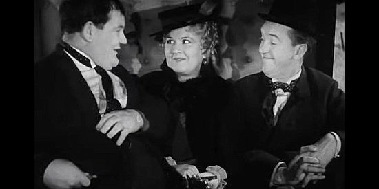 Vivien Oakland as the sheriff's wife, caught beetween Ollie Sharon (Oliver Hardy) and Stanley Oliver (Stan Laurel) on a stagecoach ride in Way Out West (1937)
