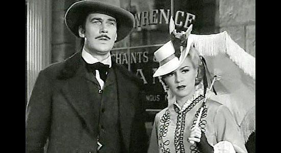 Walter Pigeon as Will Cantrell and Claire Trevor as Mary McCloud, not quite sure what to make of the new Texan in town in Dark Command (1940)