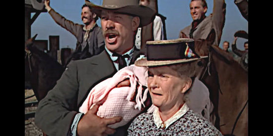 Ward Bond as Sheriff Sweet and Mae Marsh as his wife, with the infant they've agreed to care for in Three Godfathers (1948)