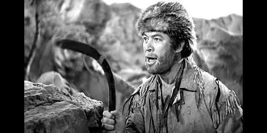 Ward Bond as Ape, preparing to use his boomerang during an Indian attack in Kit Carson (1940)