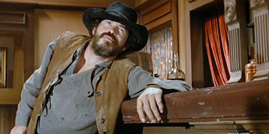 Warren Oates as Floyd Moon, a small-time crook about to pull a gun on a lawman in There Was a Crooked Man (1970)
