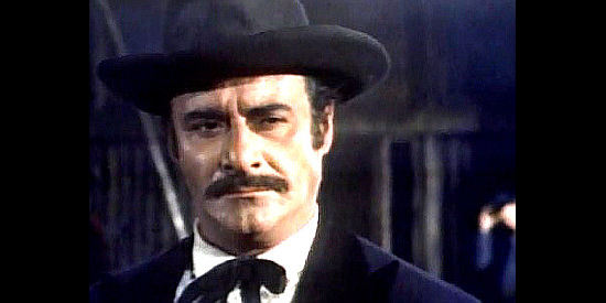 Adriano Micantoni (Mike Anthony) as Chris Jefferson, the man who considers himself the brains of the Jefferson operation in Johnny West (1965)